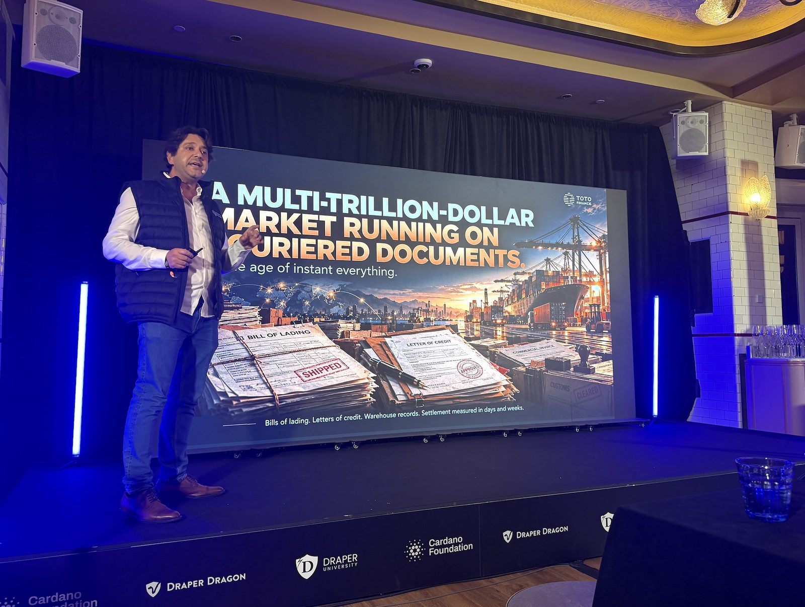 Steven Gaertner presenting the slide A Multi-Trillion-Dollar Market Running on Couriered Documents at the Draper UTXO Pitch Night